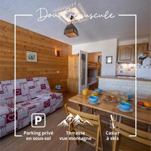 a kitchen and a living room with a couch and a table at Doux Crépuscule - Au bord des pistes - Parking in Enchastrayes