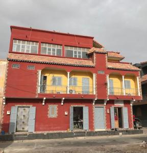 a red and yellow building with a balcony at THURIN IMO (Nord) in Saint-Louis