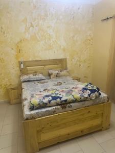 a bedroom with a wooden bed in a room at THURIN IMO (Nord) in Saint-Louis