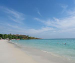 a group of people in the water on a beach at Ban Chang Pet-friendly Hotel by SCN in Ban Chang