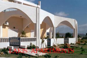 a white building with arches on the side of it at LAKIS APPARTMENTS in Faliraki