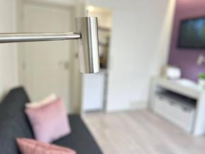 a silver object in a living room with a couch at Apt 07 Beachside Beauty Central Studio Steps from Cafes in Brighton & Hove +46 photos