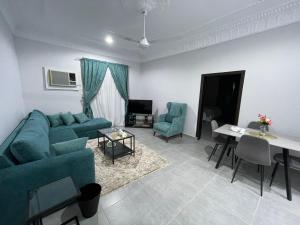 a living room with a couch and chairs and a table at Jabal Al Nour Apartment in Makkah