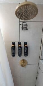 a bathroom with four bottles ofodorizers on a wall at New Downtown Tampa Cottage for 4 in Tampa