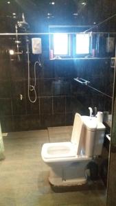 a bathroom with a toilet and a sink at Lavania Villa in Attidiya