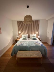 a bedroom with a bed and a pendant light at BaySun Apartment & SPA - Bayline in Armação de Pêra