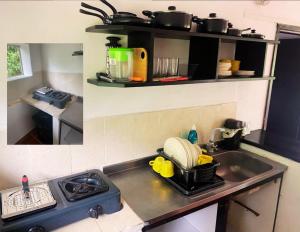 a kitchen with a sink and a stove with pots and pans at Apartamentos Sol de Coveñas TI in Coveñas +28 photos