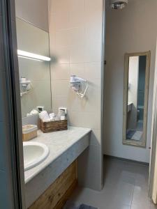 a bathroom with a sink and a mirror at Eporedia 222 in Ivrea