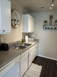 a kitchen with white cabinets and a sink at Savana spectacular loft in Los Angeles