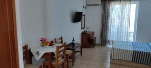 a living room with a table and a dining room at VENOS APARTMENTS in Marmari
