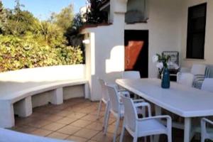 a white table and chairs on a patio at Confortevole Villino a San Felice Circeo in San Felice Circeo