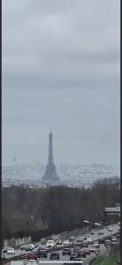 a highway with a lot of cars and the eiffel tower at Expo Paris Versailles in Paris