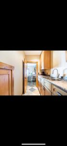 a kitchen with wooden cabinets and a sink at Heart West Haven in Priddis