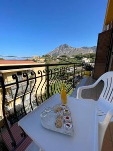 a plate of food on a table on a balcony at HIMERA LOFT - Holiday Home and Apartment in Termini Imerese