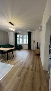 an empty living room with a table and a couch at CityCenterApartments/M32/6 in Bielsko-Biała