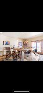 a living room with a wooden table and chairs at Heart West Haven in Priddis
