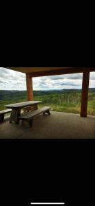 a picnic bench sitting on the side of a road at Heart West Haven in Priddis
