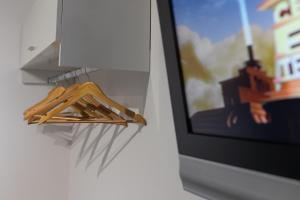 a group of wooden hangers next to a tv at Stornoway Bed and Breakfast in Stornoway