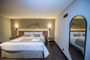 Postel nebo postele na pokoji v ubytování Pinot Hotel