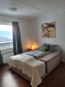 a bedroom with a bed with a view of the ocean at Fjellveien 4 in Vadsø