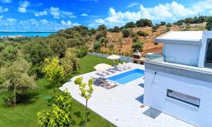 an aerial view of a house with a swimming pool at Moonlights Villas Heated Pool in Georgioupoli