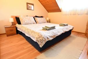 a bedroom with a bed with two towels on it at Smestaj SIMOVIC 1 in Arilje