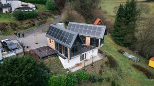an aerial view of a house with solar panels on it at Taunus Tinyhouse in Weilrod