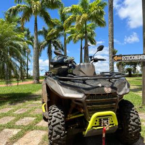 an atv parked in a park with palm trees at SR Boutique Hotel in São Pedro