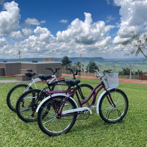 two bikes parked on the grass in a field at SR Boutique Hotel in São Pedro