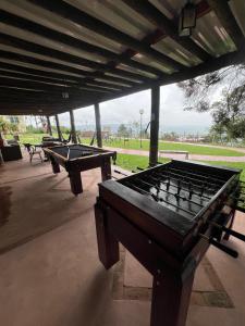 two ping pong tables sitting under a pavilion at SR Boutique Hotel in São Pedro