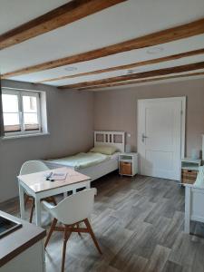 a room with a bed and a desk and a table at Ferienhof Klemme in Rinteln