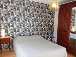 ein Schlafzimmer mit einer Vogeltapete an der Wand in der Unterkunft Chambres au Manoir 3 au 8 juin ! in Subles