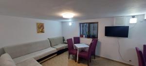 a living room with a couch and a table at CASA RYANA SINAIA in Sinaia