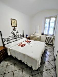 a bedroom with a large white bed with two shoes on it at -La Terrazza nel Vigneto- [Golfo dei Poeti] in Tellaro
