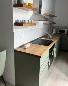 a kitchen with a counter and a stove top oven at Green Apartment Durrës in Durrës
