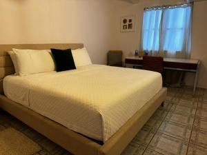 a bedroom with a large bed with white sheets and pillows at BOHO Beach Club in Boqueron