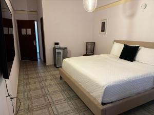 a bedroom with a bed and a hallway at BOHO Beach Club in Boqueron