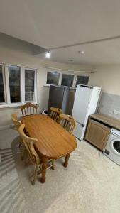 a kitchen with a wooden table and four chairs at Double Room Clontarf House-3 in Dublin