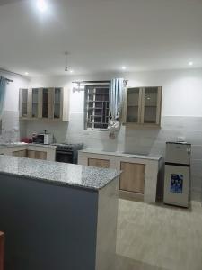a large kitchen with a counter in a room at Lagos Diani in Diani Beach