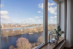 a large window with a view of a river at City Center Luxury Apartment in Tartu