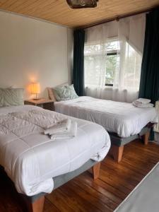Una cama o camas en una habitación de Casa Balmaceda Backpackers