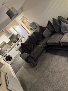 an overhead view of a living room with a brown couch at Central 2 bedroom apartment in Wick