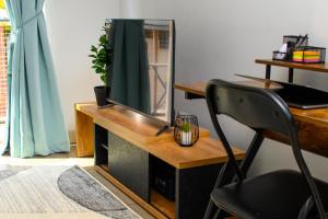a desk with a mirror and a chair in a room at Entire Studio Apartment in Maboneng in Johannesburg +22 photos