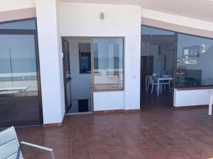 a room with glass doors and a table and chairs at B&B Vista Mare in Rodi Garganico