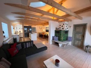 a living room with a black couch and a table at NEU - traumhafte Ferienwohnung mit Bergblick in Lenggries