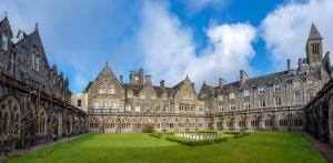 a large building with a lawn in front of it at Major's Apartment 3 Bedroom Self Catering Property in historic Abbey in Fort Augustus