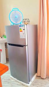 a refrigerator with a fan on top of it at Kilimanjaro poa in Moshi