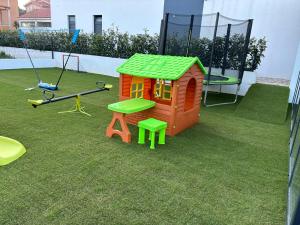 a small play house and a swing on the grass at Villa Magic Sky II in Kraj +41 photos