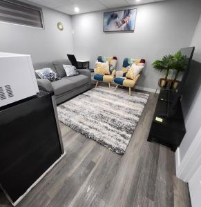 a living room with a couch and a tv at Entire Basement Suite with Private Entrance in Winnipeg