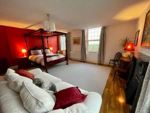 a living room with a couch and a bed at Spacious Garden Flat in Snowdonia National Park in Brynkir